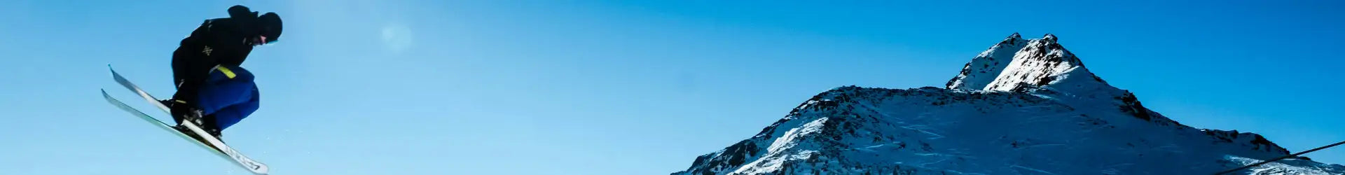 Snow-covered mountain peak under a clear blue sky.